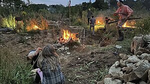 Thumbnail of Gylleboverket artwork, featuring human beings amid fire in a liminally natural environment.