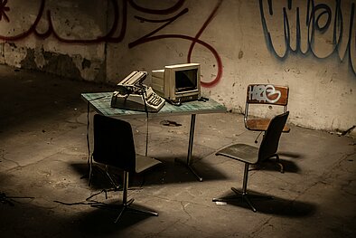 Photograph of broken computer on desk.